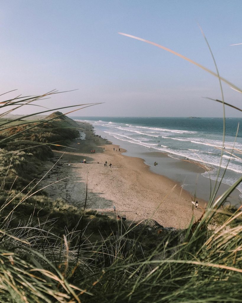 a beach with waves crashing on the shore